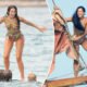 Dua Lipa leaps into the ocean, balances on surfboard while laughing with chums