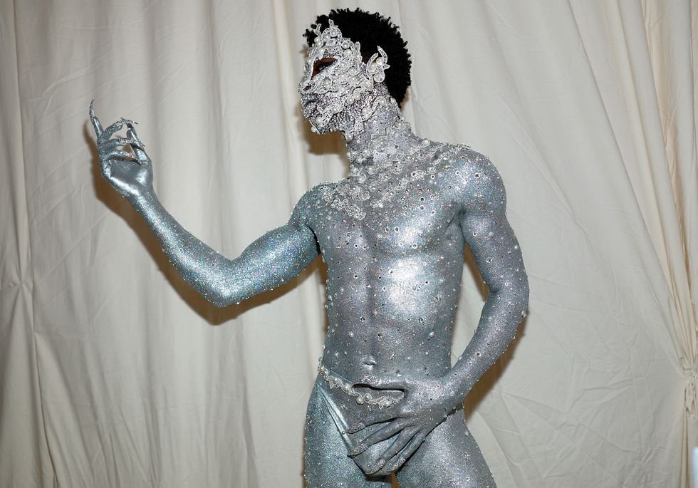 Lil Nas X Showed Up to the Met Gala in Nothing But a Metallic Thong, Silver Physique Paint, and Jewels